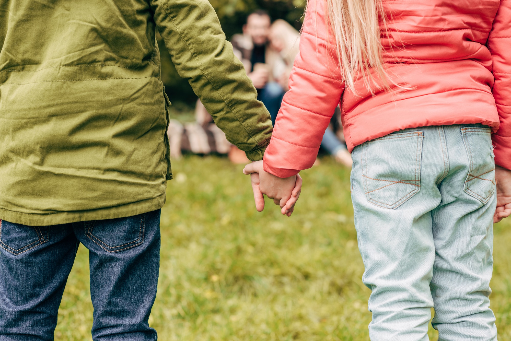 cropped shot of cute little children holding hands outdoors